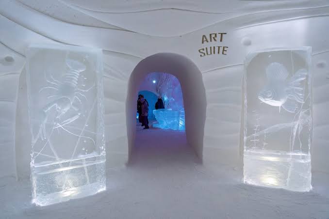 A vaulted hall carved from snow, lit from within the walls