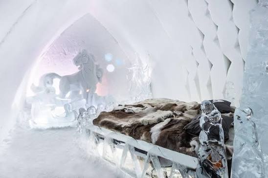 A snow-walled corridor with doorways cut into either side